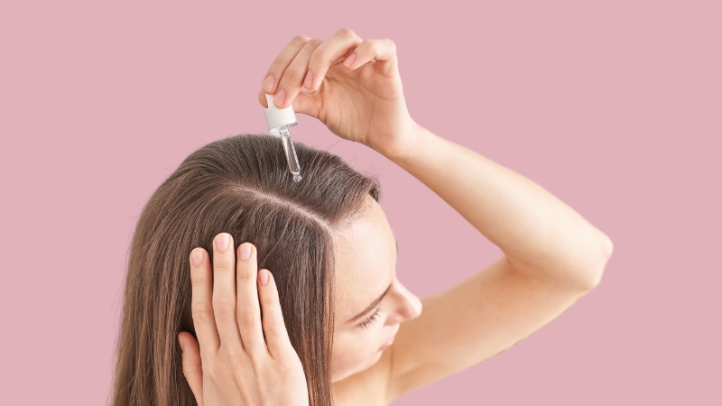 A Woman Applying Rosemary Oil Directly to Her Scalp for Better Hair Growth